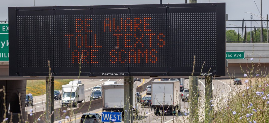 A message on an electronic road sign in Michigan warns drivers that text messages about unpaid tolls are scams.
