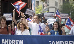 Former Gov. Andrew Cuomo joins Assembly Member Yudelka Tapia, left, and state Sen. Jessica Ramos, right, at a Puerto Rican Day Parade on June 8.