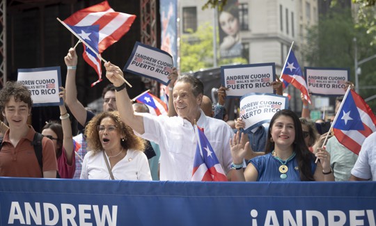 Former Gov. Andrew Cuomo joins Assembly Member Yudelka Tapia, left, and state Sen. Jessica Ramos, right, at a Puerto Rican Day Parade on June 8.