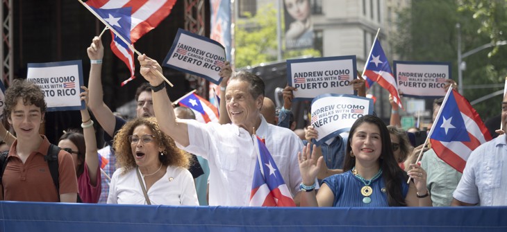 Former Gov. Andrew Cuomo joins Assembly Member Yudelka Tapia, left, and state Sen. Jessica Ramos, right, at a Puerto Rican Day Parade on June 8.