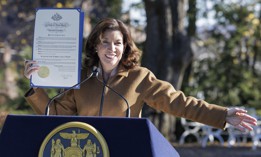 Gov. Kathy Hochul holds up a pardon for a turkey named Sullivan at a Thanksgiving celebration on Nov. 24, 2021.
