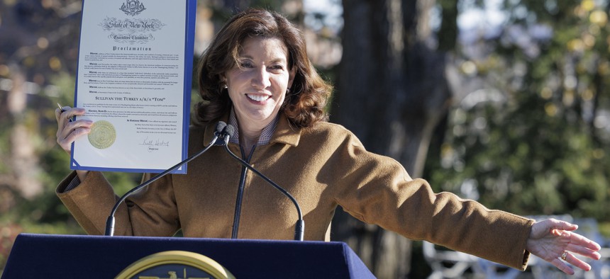 Gov. Kathy Hochul holds up a pardon for a turkey named Sullivan at a Thanksgiving celebration on Nov. 24, 2021.