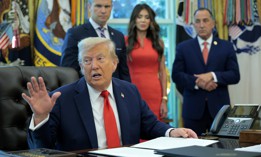 President Donald Trump signs an executive order threatening states that limit the use of bail on Aug. 25, 2025.