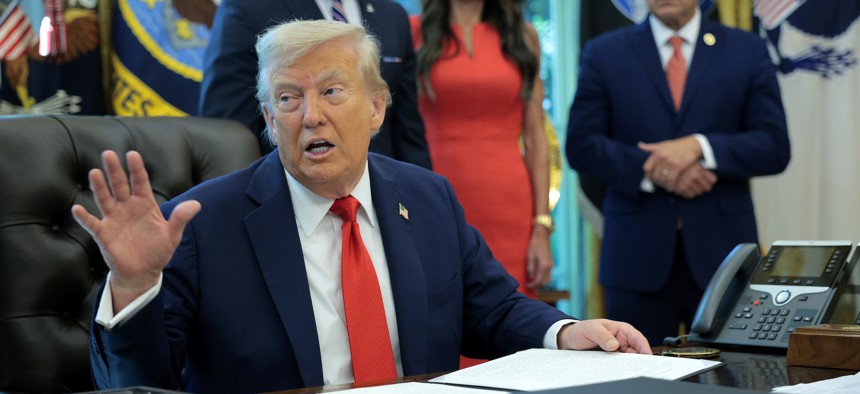 President Donald Trump signs an executive order threatening states that limit the use of bail on Aug. 25, 2025.