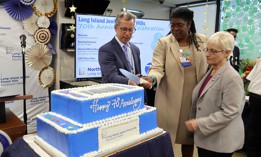 John D’Angelo, senior vice president and regional executive director at Northwell, helps Lorraine Chambers Lewis, executive director of Northwell Long Island Jewish Forest Hills in Queens and Council Member Lynn Schulman celebrate the hospital’s 70th anniversary of serving the health care needs of the community in August 2023. 