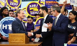 Democratic mayoral nominee Zohran Mamdani, center, rallies with 32BJ SEIU President Manny Pastreich, left, and Hotel & Gaming Trades Council President Rich Maroko, right, on July 2, 2025.