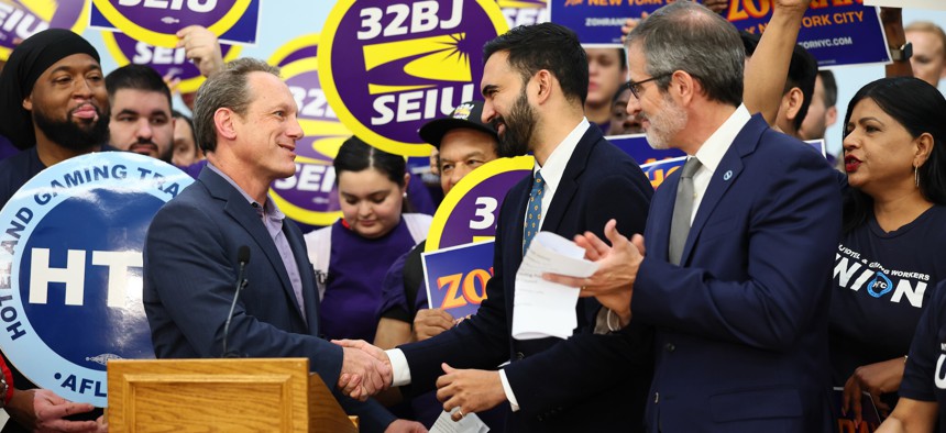 Democratic mayoral nominee Zohran Mamdani, center, rallies with 32BJ SEIU President Manny Pastreich, left, and Hotel & Gaming Trades Council President Rich Maroko, right, on July 2, 2025.