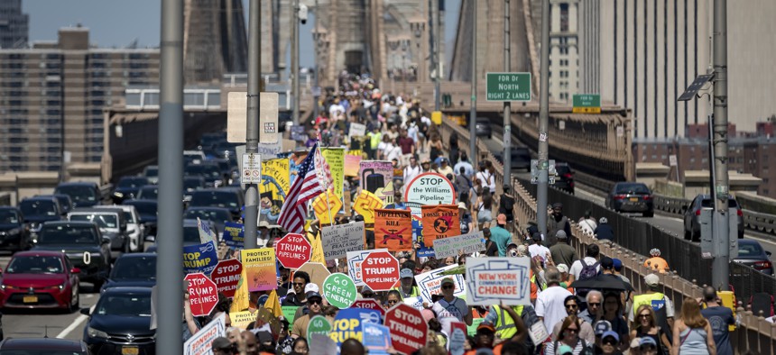 Climate activists march across the Brooklyn Bridge to demand that Gov. Kathy Hochul reject a natural gas pipeline project.