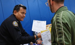 A Department of Correction recruiter shares hiring info at a job fair on Staten Island in March. 