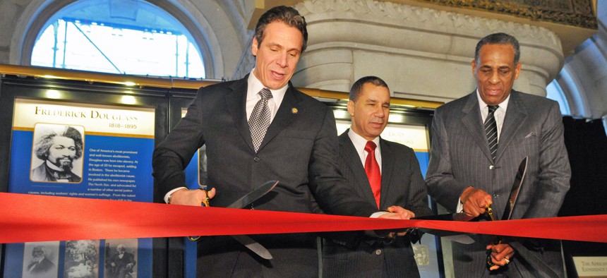 Then Gov. Andrew Cuomo cuts a ribbon on a Black history exhibit with former Gov. David Paterson and then-SUNY Board of Trustees Chair Carl McCall in 2012.