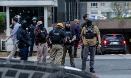 Federal agents and law enforcement stand outside 26 Federal Plaza following an ICE raid in Manhattan on Oct. 21, 2025.