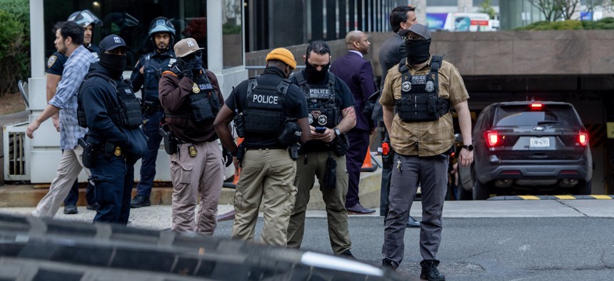 Federal agents and law enforcement stand outside 26 Federal Plaza following an ICE raid in Manhattan on Oct. 21, 2025.