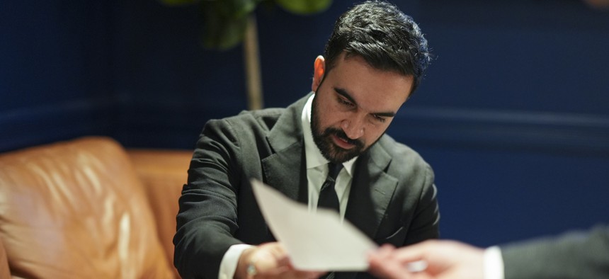 Democratic mayoral nominee Zohran Mamdani looks over his notes before the first general election mayoral debate on Oct. 16, 2025.