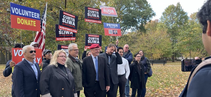 Alicia Vaichunas, second from left, campaigns in Middle Village with Republican nominee for mayor Curtis Sliwa (red beret).