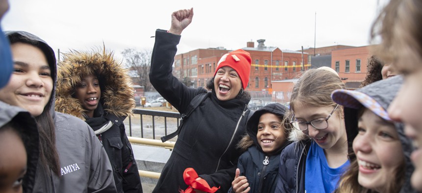 New York City Council Member Alexa Avilés joins with middle-school students to cut the rope on a new pedestrian bridge on Jan. 23, 2023.