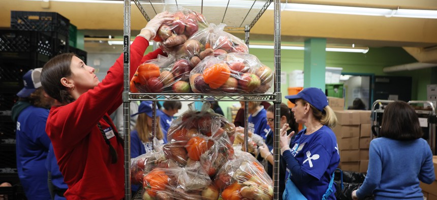 Volunteers with New York Common Pantry help to prepare food packages on October 30, 2025 in New York City.