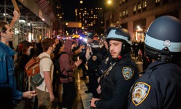 NYPD officers monitor a protest after federal agents conducted a dramatic raid on Canal Street on Oct. 21.