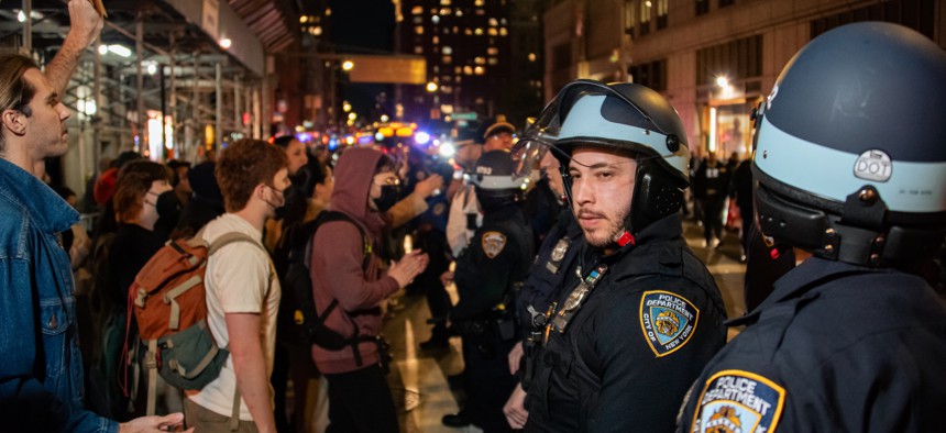 NYPD officers monitor a protest after federal agents conducted a dramatic raid on Canal Street on Oct. 21.