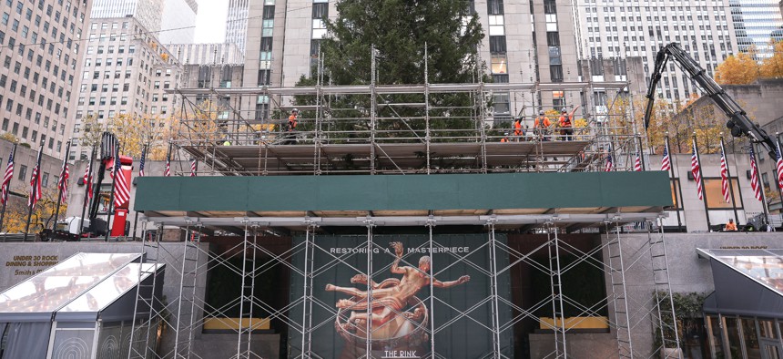 Workers stand on scaffolding at Rockefeller Center on Nov. 8, 2025.