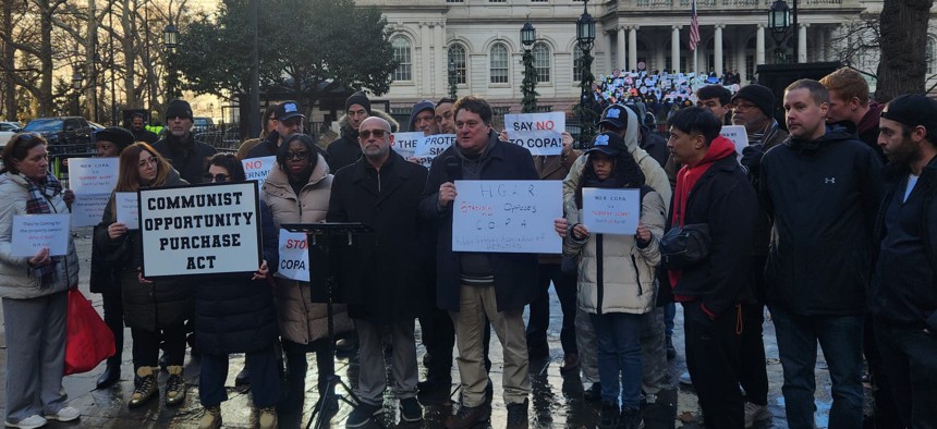 Opponents of the Community Opportunity to Purchase Act rally outside City Hall on Dec. 18, 2025.