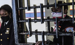 Correction officers watch as New York City Mayor Eric Adams tours Rikers Island on June 22, 2022.