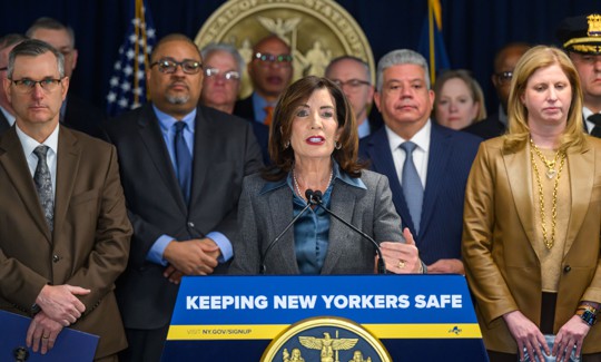 Flanked by law enforcement officials, Gov. Kathy Hochul announces her proposal for a statewide ban on cooperation agreements between local law enforcement and ICE.