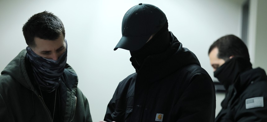 Masked federal agents patrol the halls of immigration court at the Jacob K. Javits Federal Building on Feb. 4, 2026 in New York City.