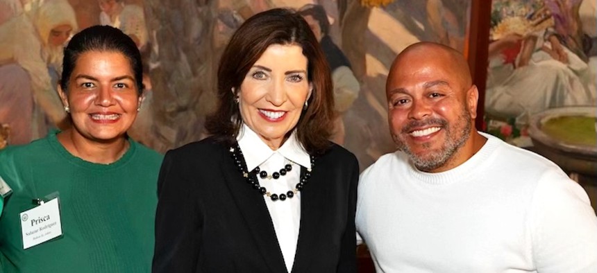 Prisca Salazar Rodriguez, left, and Jose Rodriguez, right, with Gov. Kathy Hochul, center.