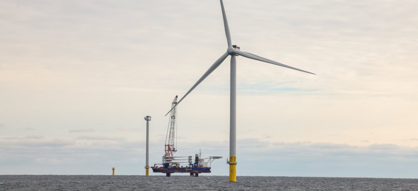 An operational wind turbine alongside two wind turbines currently under construction at the South Fork Wind Farm off Long Island on Dec. 7, 2023.