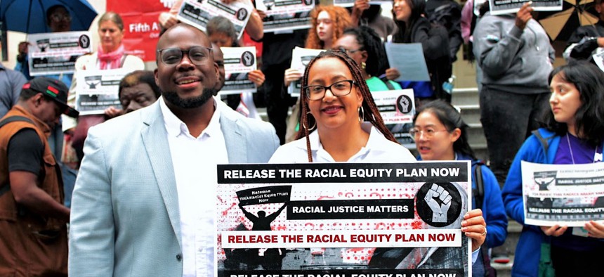 Tyrik Washington, a consultant with the New York City Commission on Racial Equity, and Linda Tigani, the commission’s executive director, attend a demonstration on the steps of City Hall.