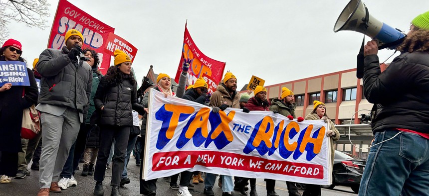 Demonstrators march to the state Capitol to pressure Gov. Kathy Hochul to tax the rich on Feb. 25, 2026.