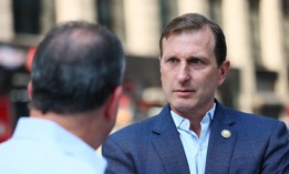 Rep. Dan Goldman, right, and then-Comptroller Brad Lander touch base outside 26 Federal Plaza in August.