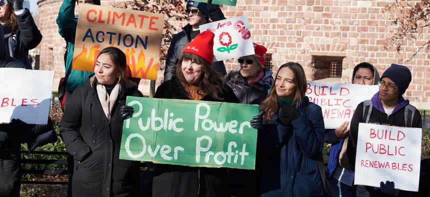 Assembly Member Emily Gallagher, center, and state Sens. Kristen Gonzalez, left, and Julia Salazar, right, attend a rally in support of public power in Battery Park in November 2023.