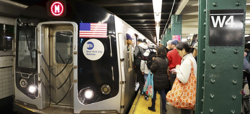 Riders board an M subway train in Manhattan, navigating just one part of a larger end‑to‑end journey.