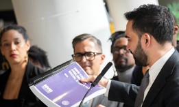 Mayor Zohran Mamdani holds the preliminary racial equity plan at a press conference announcing its release on April 6, 2026.