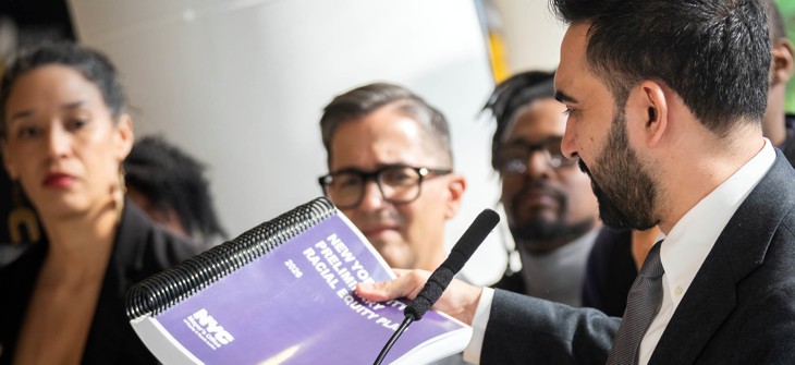 Mayor Zohran Mamdani holds the preliminary racial equity plan at a press conference announcing its release on April 6, 2026.