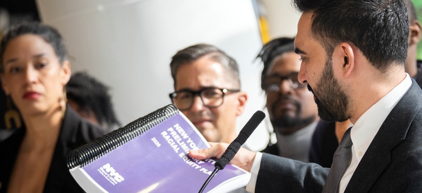 Mayor Zohran Mamdani holds the preliminary racial equity plan at a press conference announcing its release on April 6, 2026.