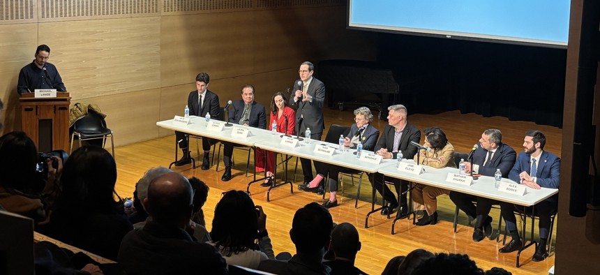 A meeting of the Micahs. Lasher speaks at a Feb. 12 candidate forum, while Bergdale, fourth from right, looks on.