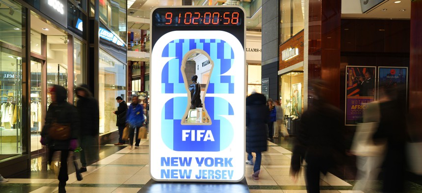 People walk past a World Cup countdown display in Manhattan.