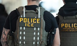 A federal immigration agent is seen at Laguardia Airport.
