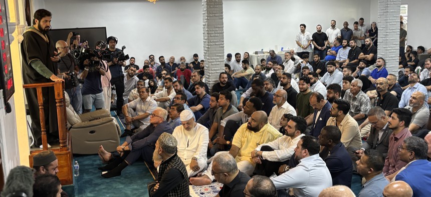 Zohran Mamdani, seated in the foreground in a white shirt, attends Friday prayers at the Centro Islamico de Puerto Rico on Nov. 7, 2025.