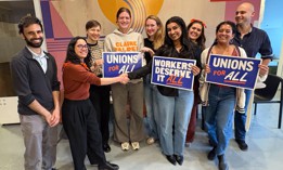 Assembly Member Claire Valdez, second from left, shakes hands with a campaign staffer after they agree to a union contract.