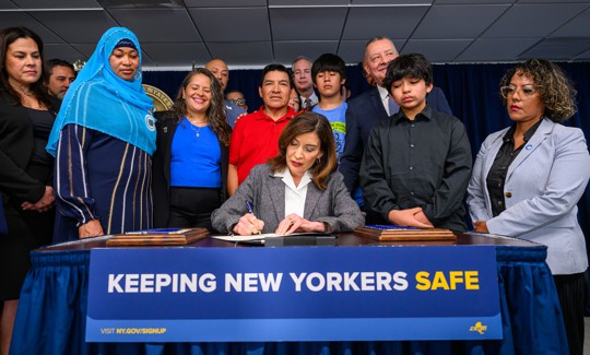 Gov. Kathy Hochul ceremonially signs a budget bill expanding immigrant protections and limits cooperation with ICE on May 29.