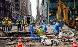 Workers begin repairs after a 127-year-old water main under Times Square breaks in August 2023.