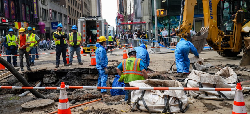 Workers begin repairs after a 127-year-old water main under Times Square breaks in August 2023.