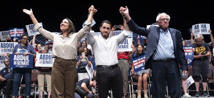 Rep. Alexandria Ocasio-Cortez, left, and U.S. Sen. Bernie Sanders, right, campaign with Abdul El-Sayed in Detroit on July 18, 2026.