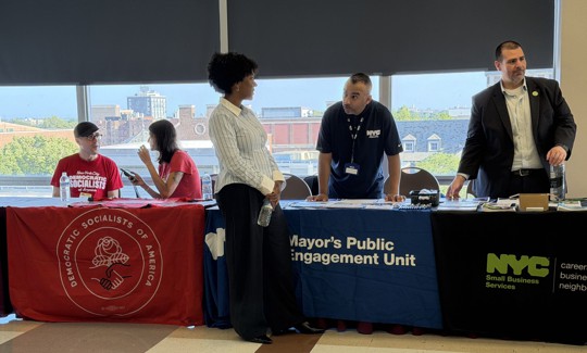 NYC-DSA members table alongside government agencies at the Mamdani’s administration’s bus rider town hall on Aug. 6, 2026.
