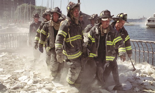 Firefighters carry an injured fellow firefighter away from the World Trade Center site on Sept. 11, 2001.
