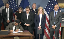 New York City Chief Counsel Ramzi Kassem, right, stands by while Mayor Zohran Mamdani signs 9/11-related executive orders on Sept. 4, 2026.