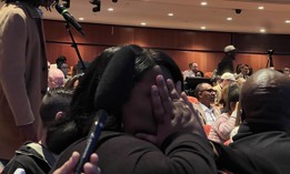 Nakisha "Nikki" Evans, a recently elected Brooklyn district leader, seeks respite behind her hands as the Brooklyn Democratic Party’s biannual organizational meeting goes off the rails. 